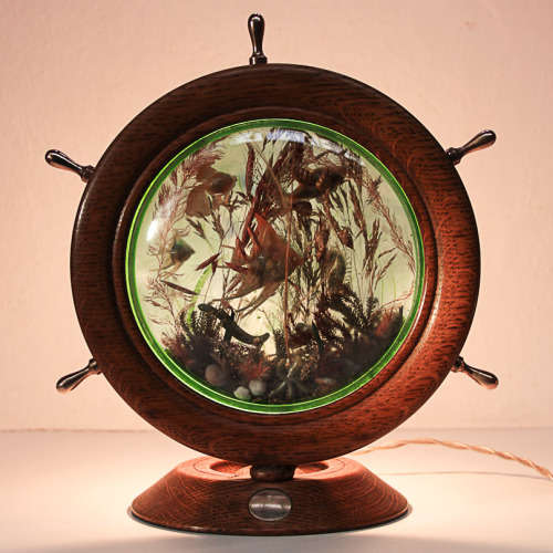 UNUSUAL LIGHT OF A SHIP WHEEL CONTAINING AN AQUARIUM - OAK, BRASS, PERSPEX - 1970's