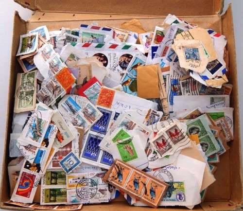 A small thin box of worldwide stamps on paper - good value!