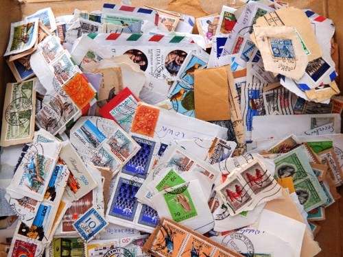 A small thin box of worldwide stamps on paper - good value!