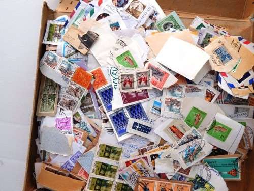 A small thin box of worldwide stamps on paper - good value!