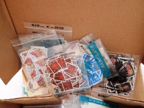 A box full of RSA stamps off and on paper in plastic packets
