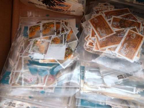 A box full of RSA stamps off and on paper in plastic packets