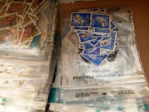 A box full of RSA stamps off and on paper in plastic packets