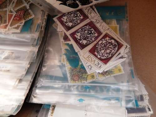 A box full of RSA stamps off and on paper in plastic packets