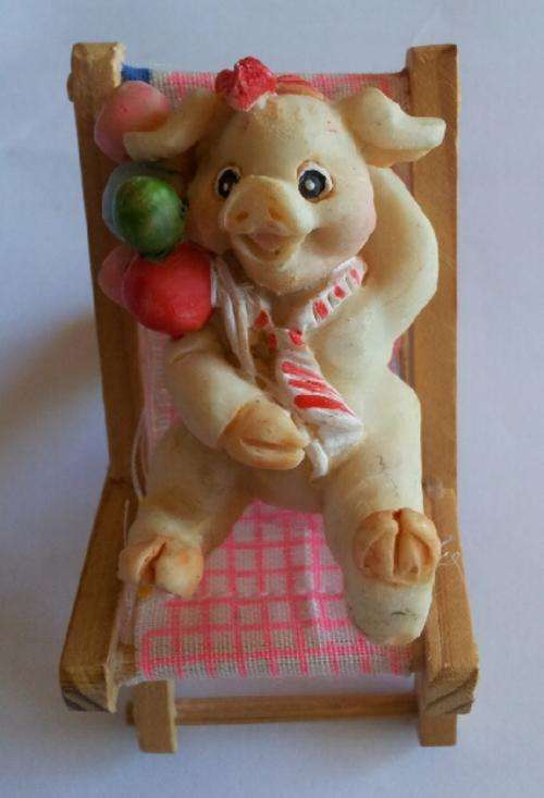 Cute little pig on a chair