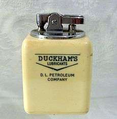 A vintage advertising table lighter