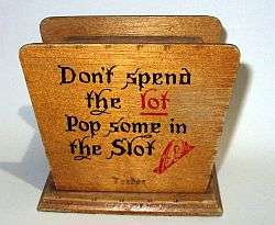 A vintage wooden money box with a secret opening