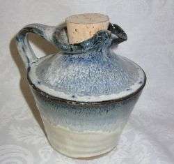 A POTTERY WINE VAT WITH MAKERS STAMP TO BASE