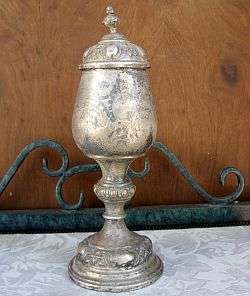 An antique silver plated urn in need of a serious polish