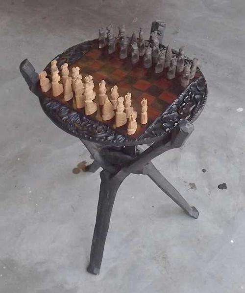 African hand carved chess set on table