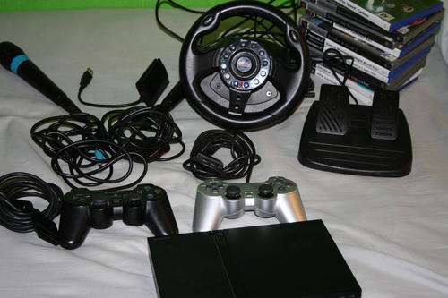 Sony Playstation 2 Slim /w 11 games, Singstar Mics and Steering Wheel!
