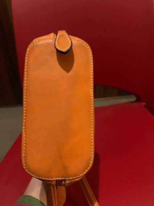 Lovely orange leather sling handbag