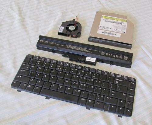 HP 510 laptop components; DVD drive, battery, keyboard and CPU fan.