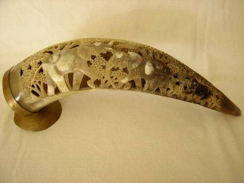 HAND CARVED BUFFALO HORN ON BRASS STAND, REDUCED BY R100.00