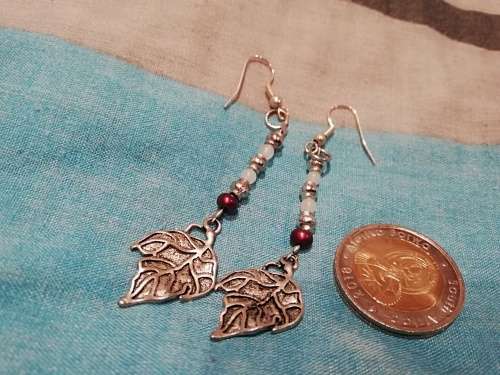 8 x dangle earrings, some with glass or gems. And one wire cross, Bulk sale together.