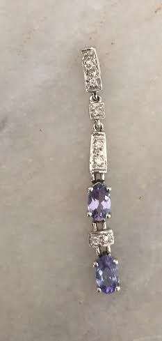 An unusual 9ct solid white gold pendant set with tanzanites and diamonds